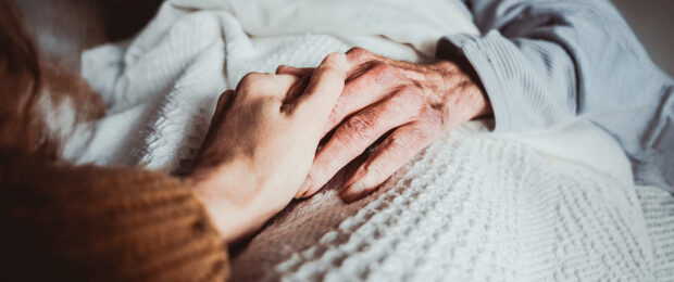 Caregiver comforting an elderly woman.